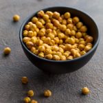 Air Fryer Chickpeas in a black bowl on a grey surface.