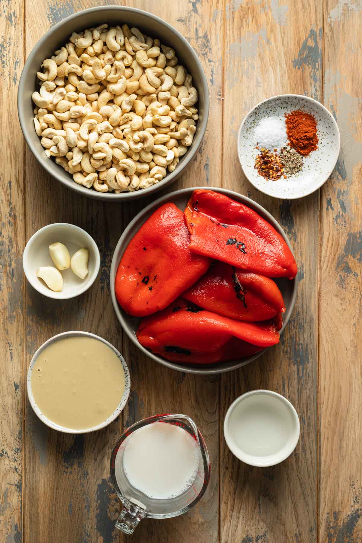 Ingredients to make roasted red pepper dip with cashews.