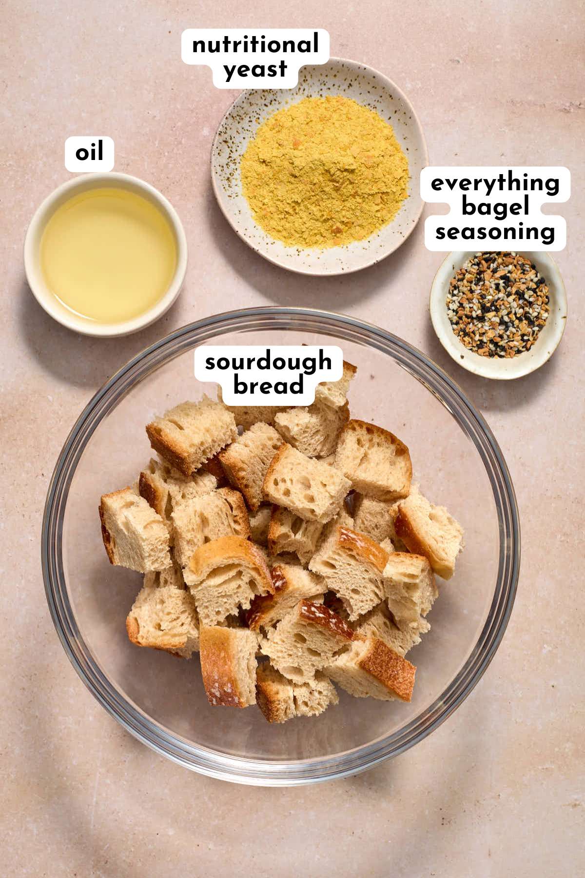 Ingredients to make sourdough croutons arranged individually and labeled.