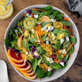 Overhead view of a large bowl of Winter Salad with Citrus Honey Dressing.