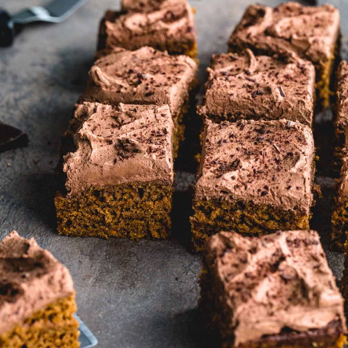 Angled view of sweet potato cake cut into squares and arranged next to each other.