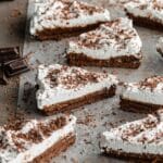 Angled view of slices of Chocolate Irish Whiskey Tart arranged on parchment paper.