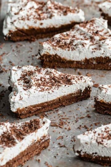 Angled view of slices of Chocolate Irish Whiskey Tart arranged on parchment paper.