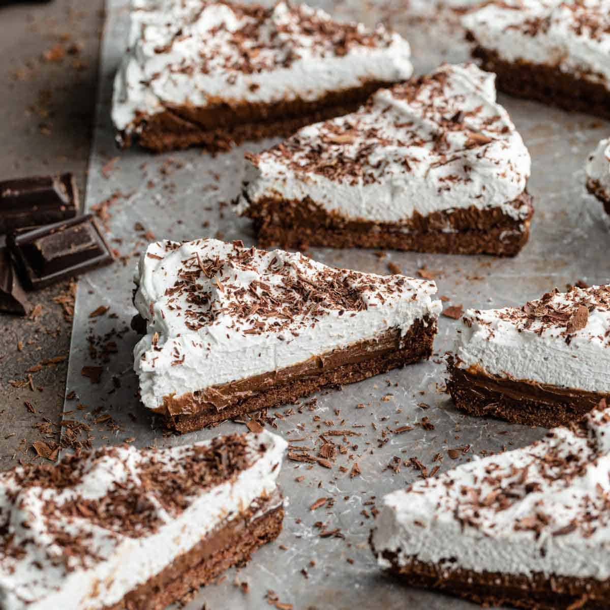 Angled view of slices of Chocolate Irish Whiskey Tart arranged on parchment paper.