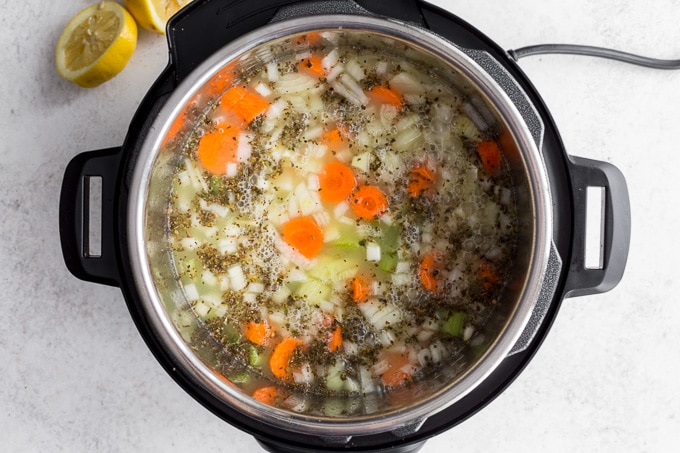 Chicken soup cooked in the Instant Pot and ready to add the orzo and kale.