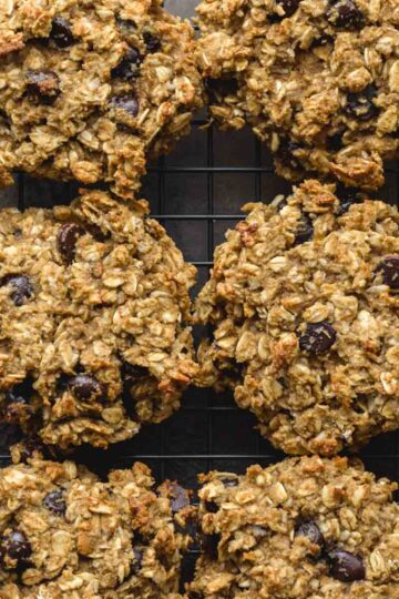Overhead close up of avocado banana breakfast cookies on a black wire rack.