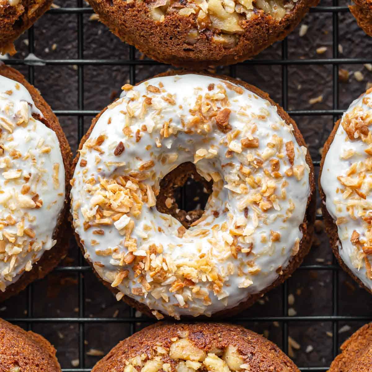 Overhead close up of carrot cake donuts on a wire cooling rack.