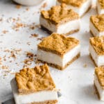 Carrot Cake Ice Cream Sandwiches cut into squares and arranged on a white surface.