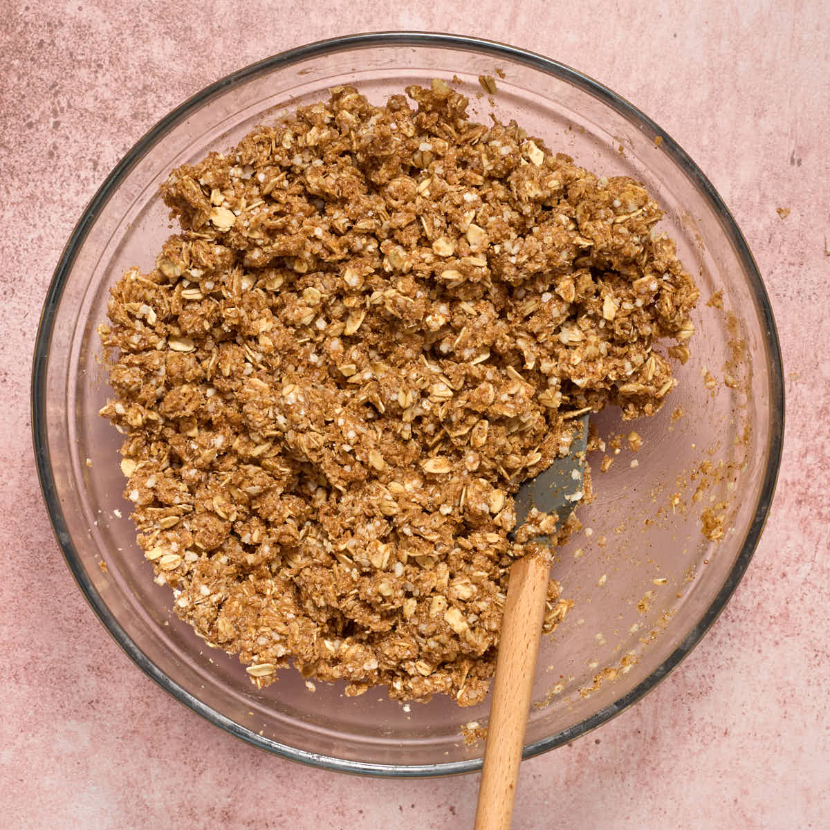 Wet ingredients stirred into the oat and quinoa mixture to form a crumbly, wet mixture.