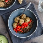 Honey garlic turkey meatballs with quinoa and peppers served in a blue bowl.