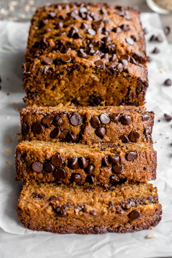 Spelt banana bread topped with chocolate chips and cut into thick slices.