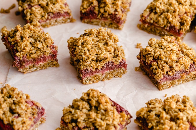 Oatmeal jam bars on parchment paper.