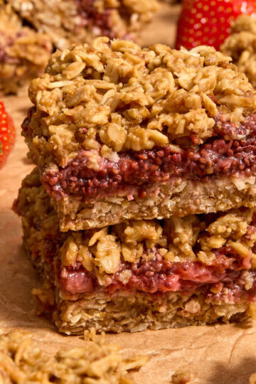 Two strawberry steel cut oat bars stacked on top of each other.