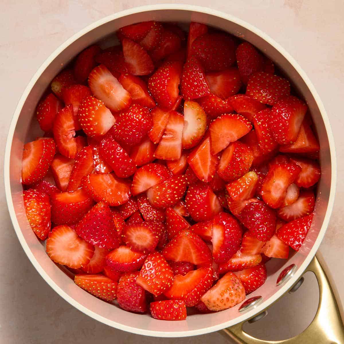 Chopped strawberries in a small sauce pan.
