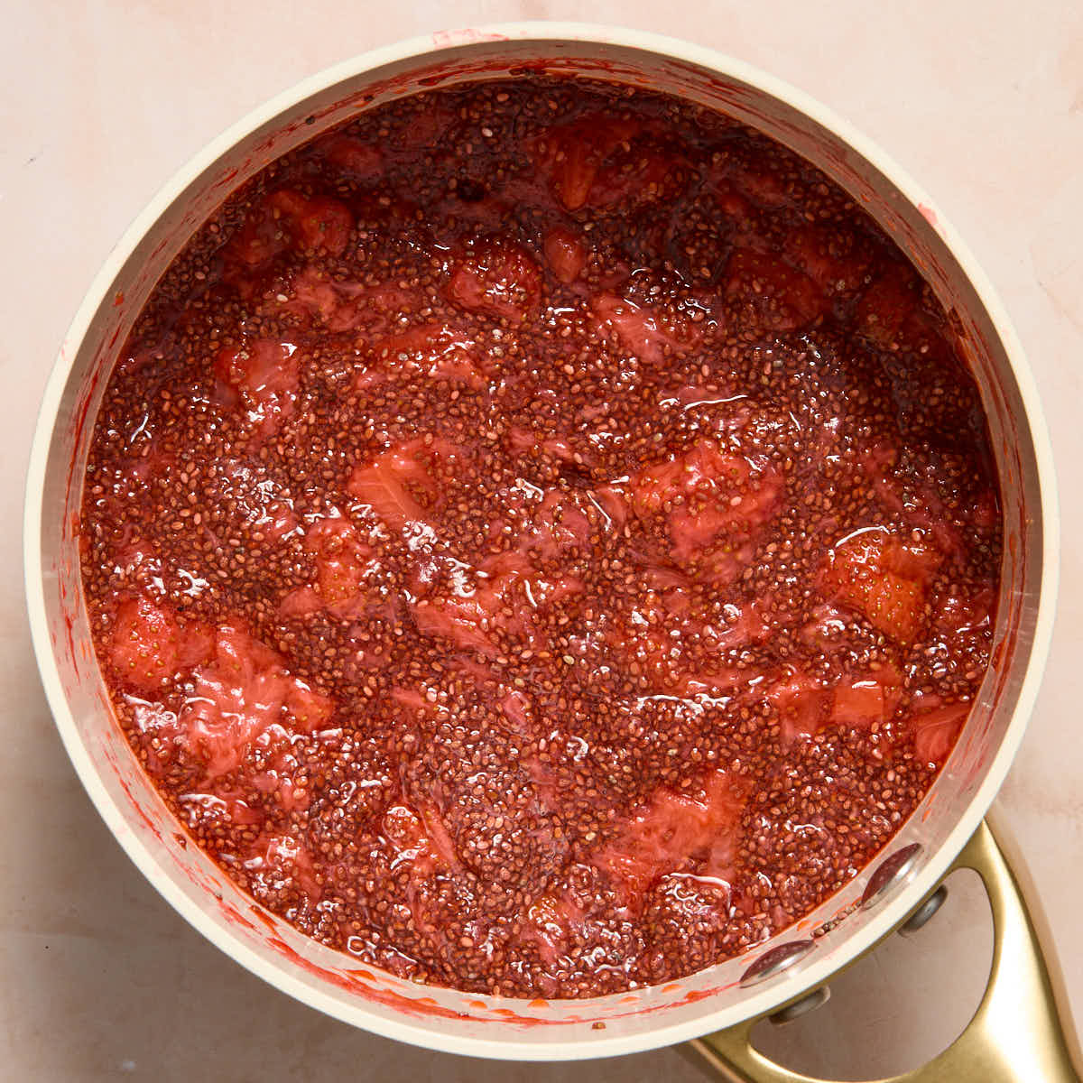 Thickened strawberry chia jam in a sauce pan.