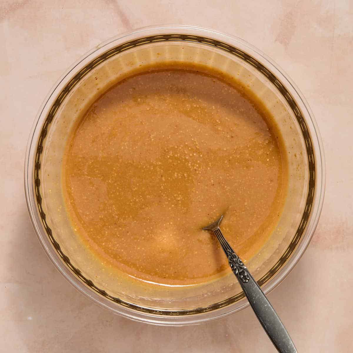 Peanut butter, maple syrup and coconut oil melted together in a bowl.