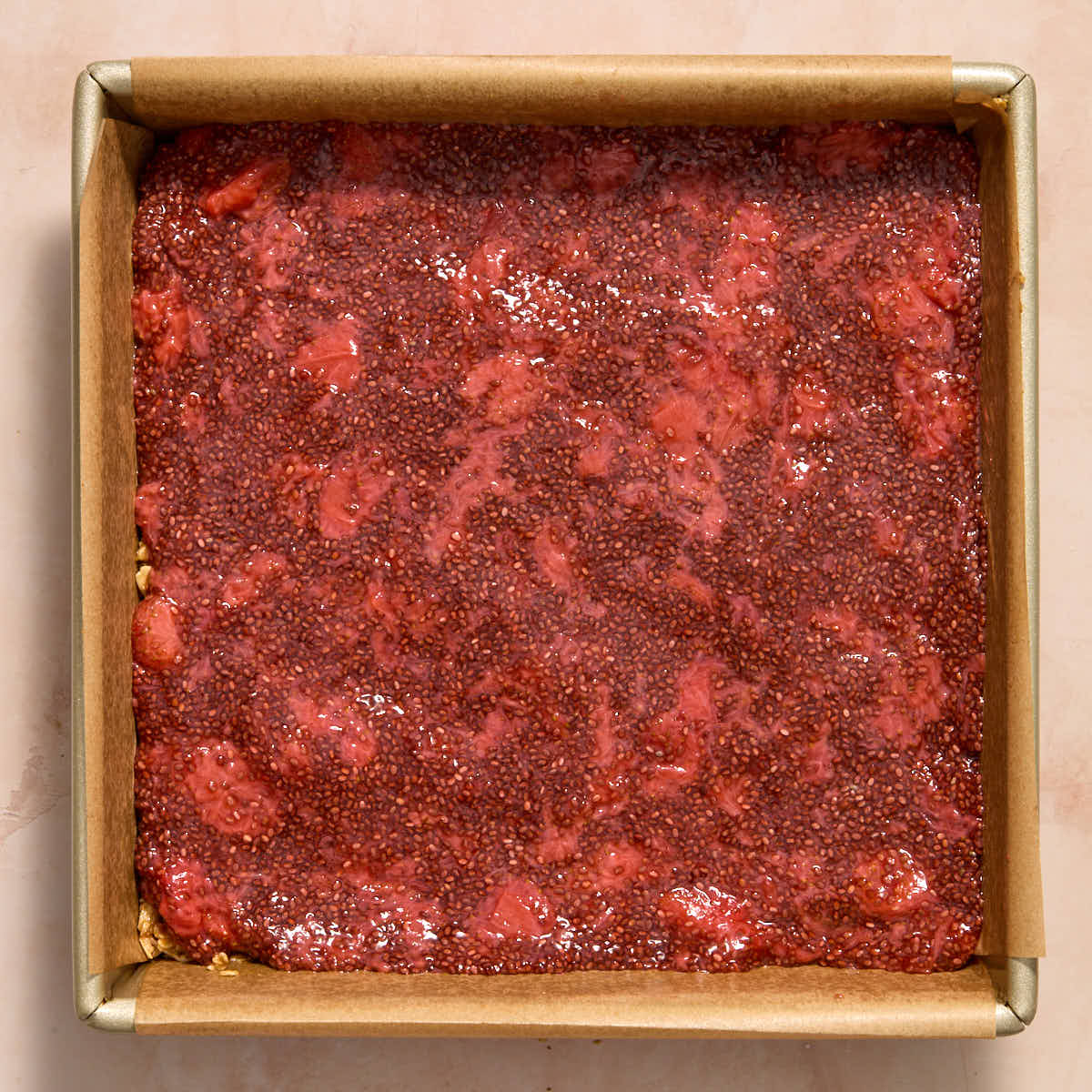 Chia jam spread out on top of the bottom oat layer.