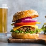 Side view of a turkey jalapeno burger topped with lettuce, cheese, tomato and red onion.