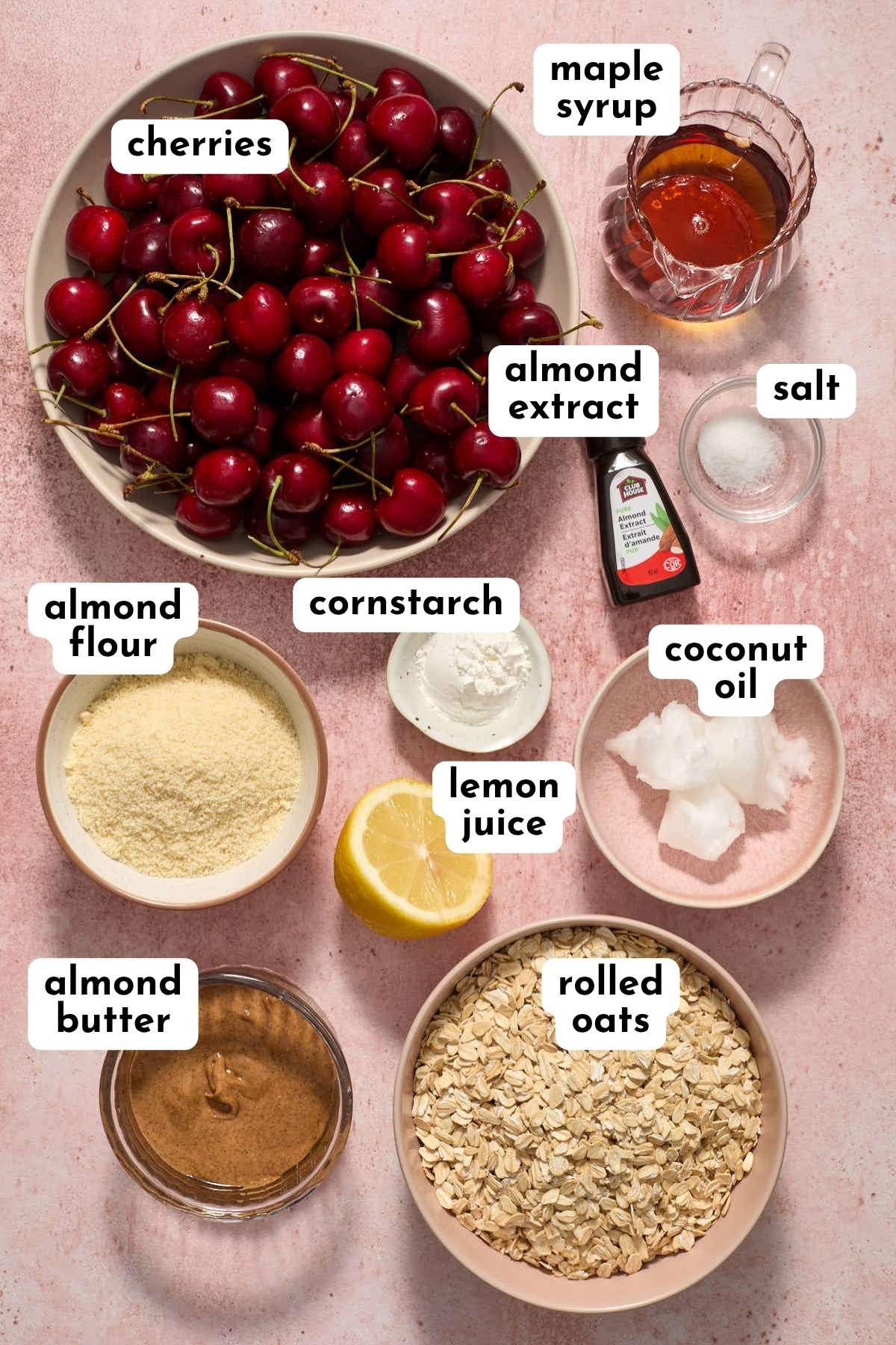 Ingredients to make gluten-free cherry crisp arranged individually and labeled.