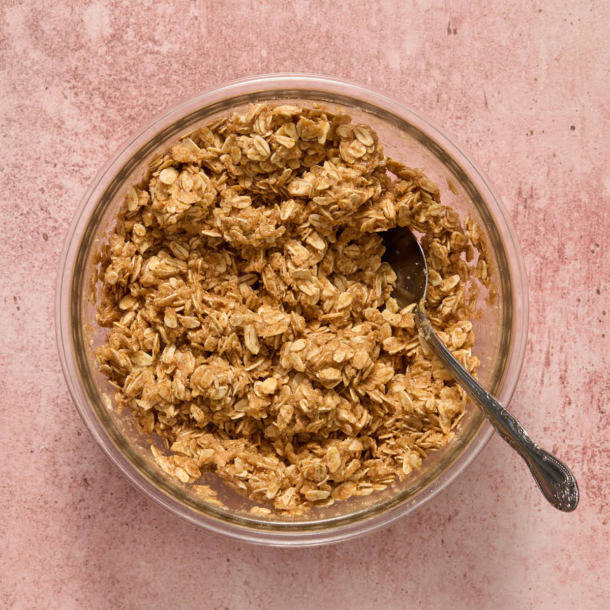 Crisp topping mixed together in a bowl with a spoon.