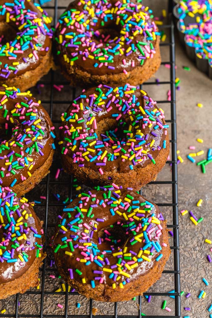 Up-close view of vegan protein doughnuts with chocolate glaze and sprinkles.