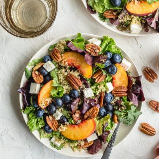 Summer Peach Salad with Blueberries served on white plates.