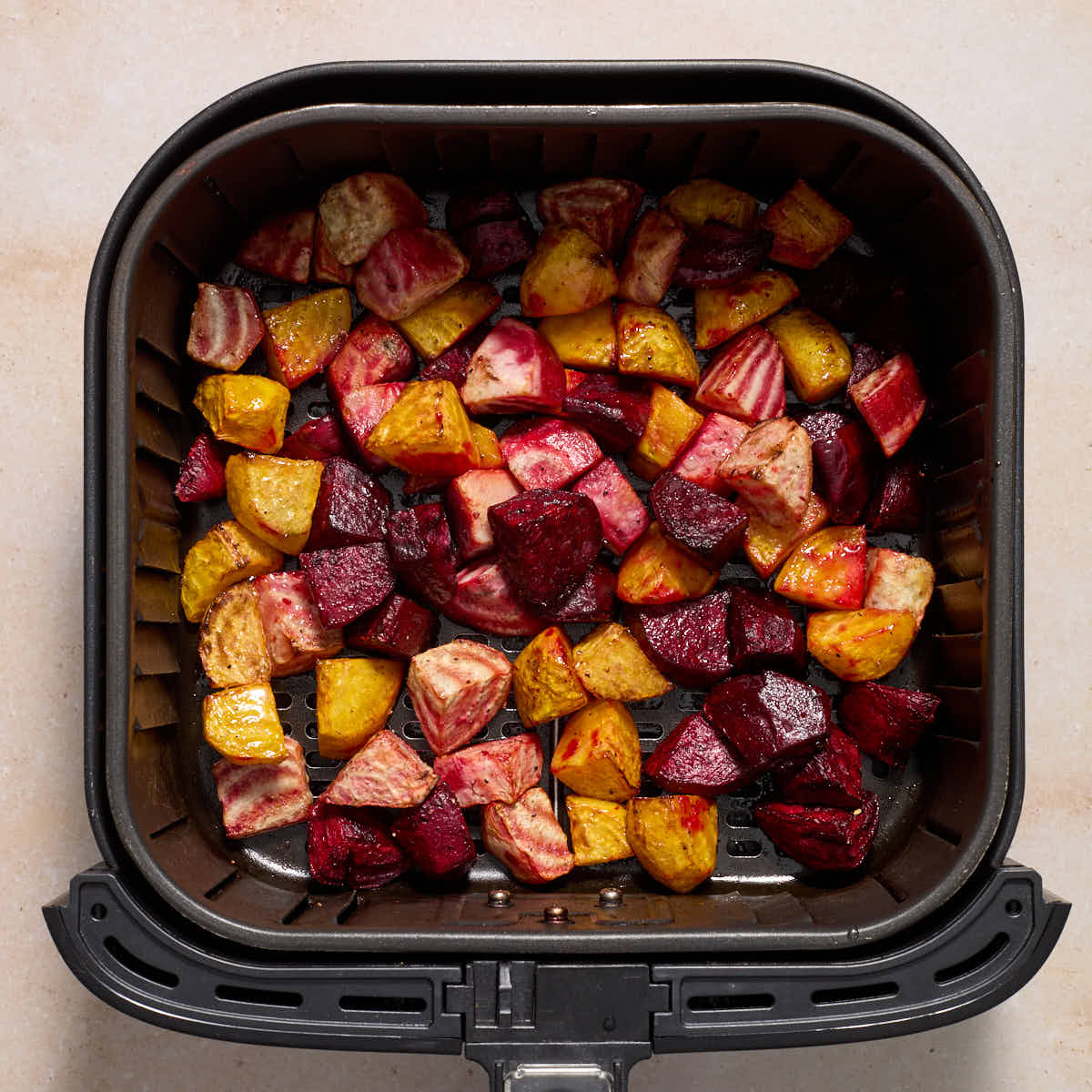 Roasted beets in an air fryer basket.