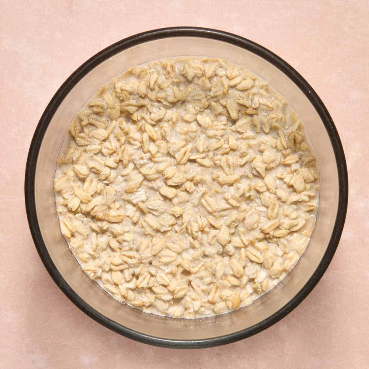 Soaked oats in a bowl with the oat milk absorbed.