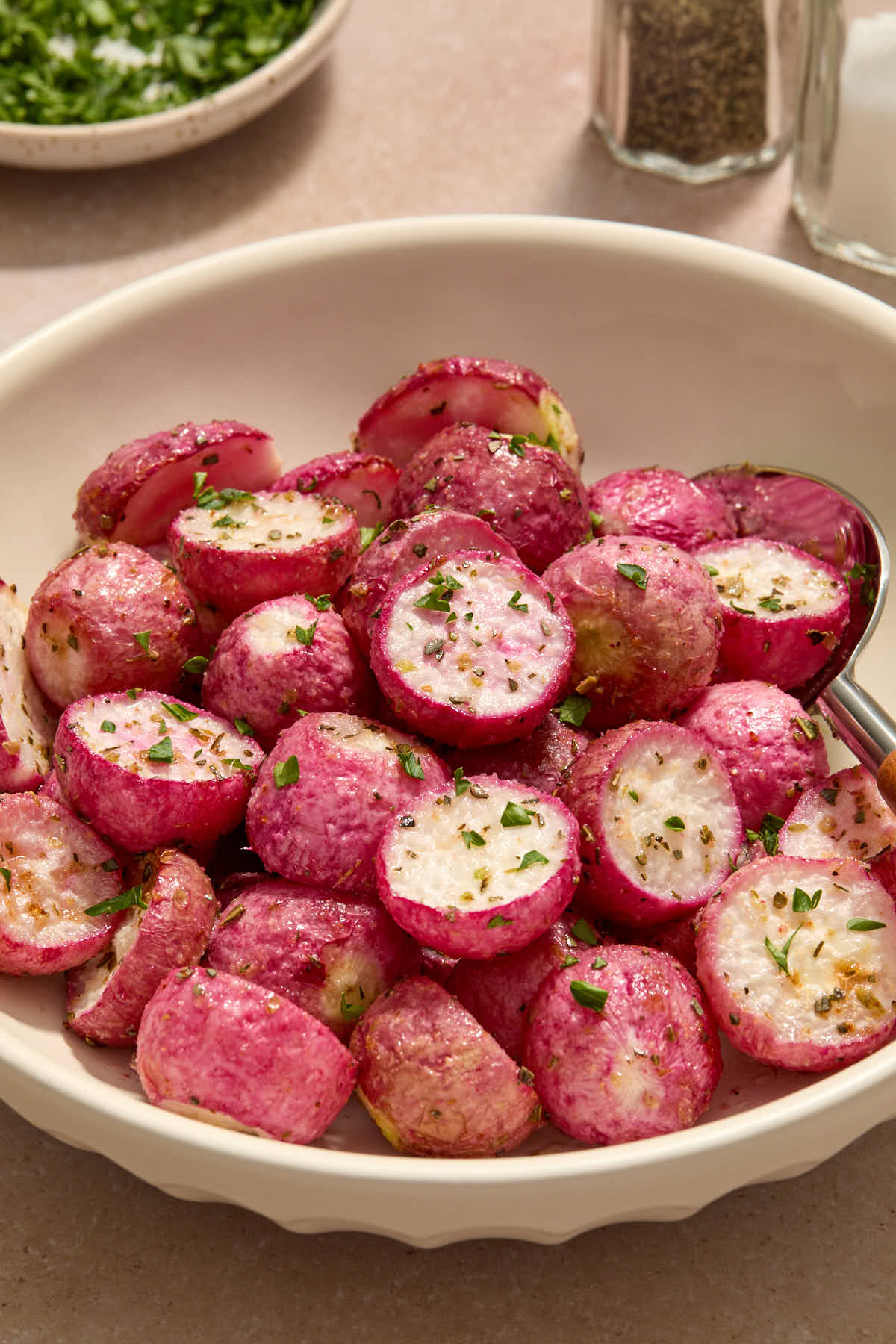 Close up side view of radishes served in a bowl.
