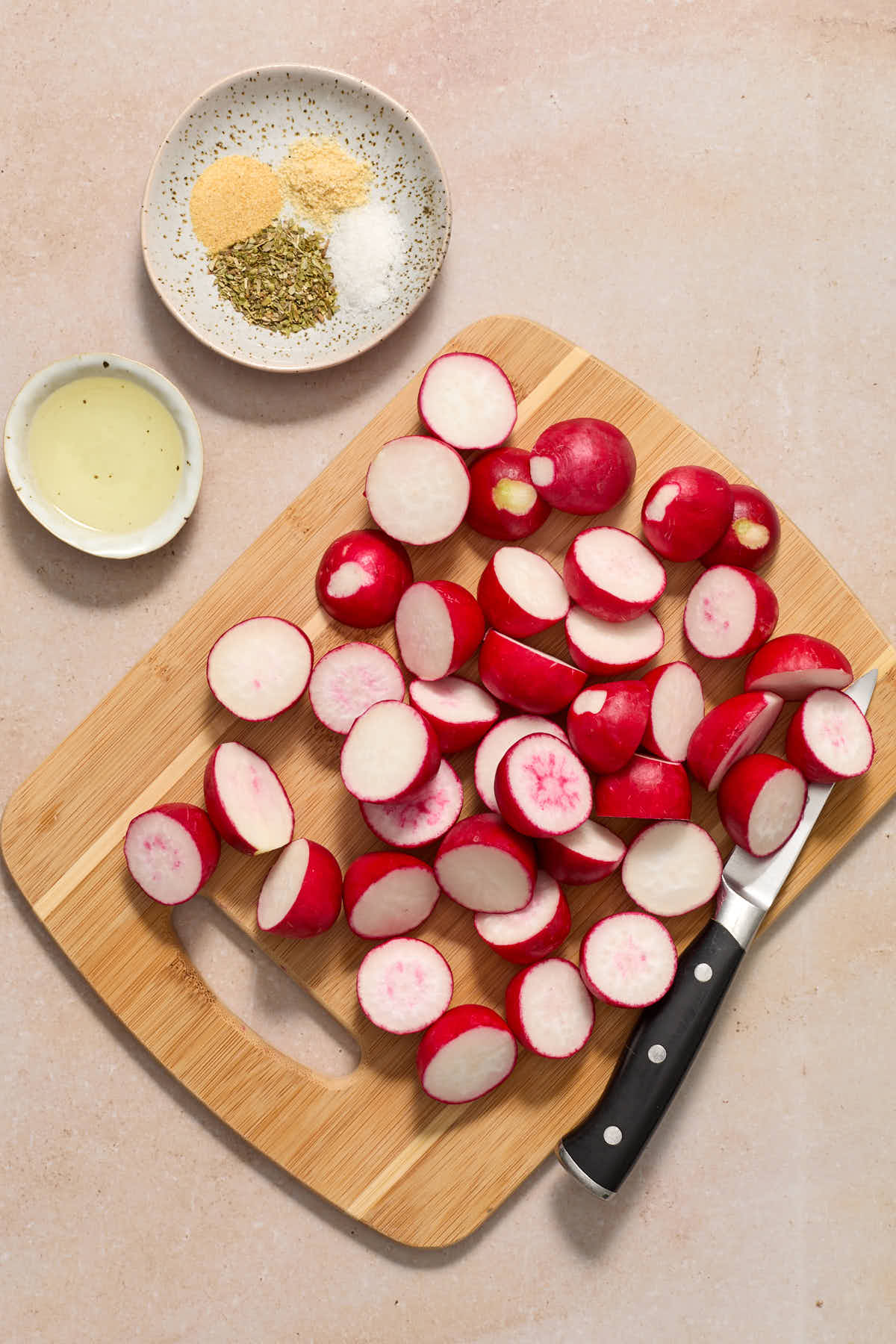 Prepped radishes on a wooden cutting board.