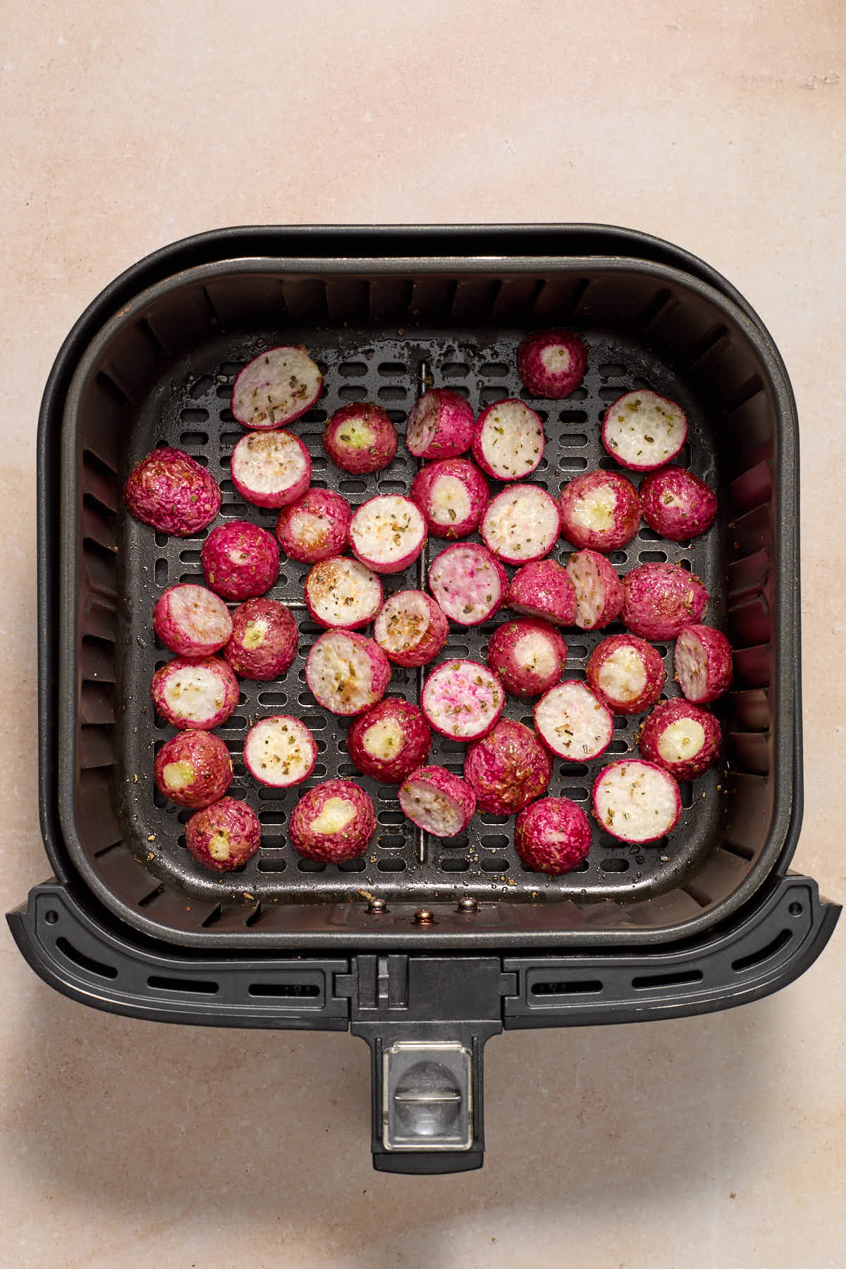 Air fried radishes in the air fryer basket.