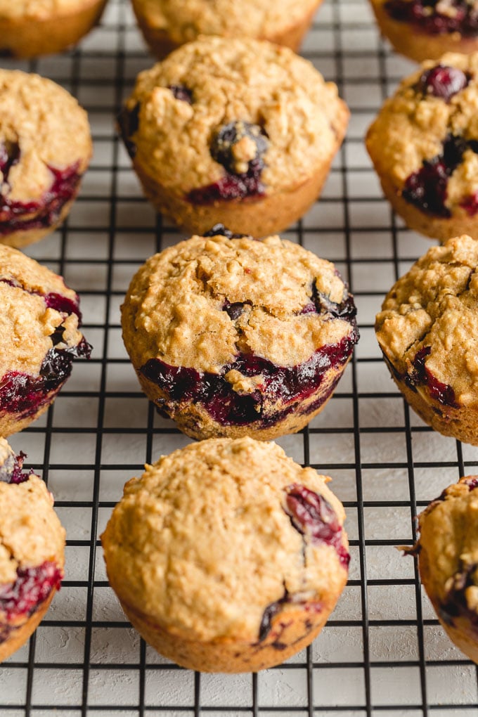 Up close view of healthy blueberry oat muffins arranged on a wire rack.