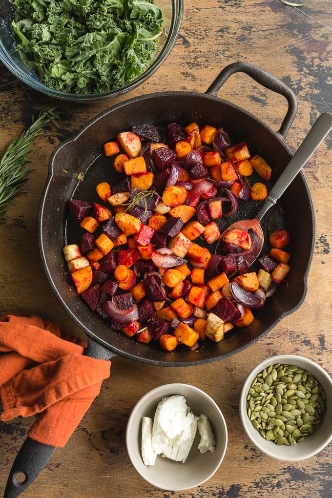 Chopped carrots, beets, parsnip, sweet potato, onion and rosemary roasted in a cast iron pan.