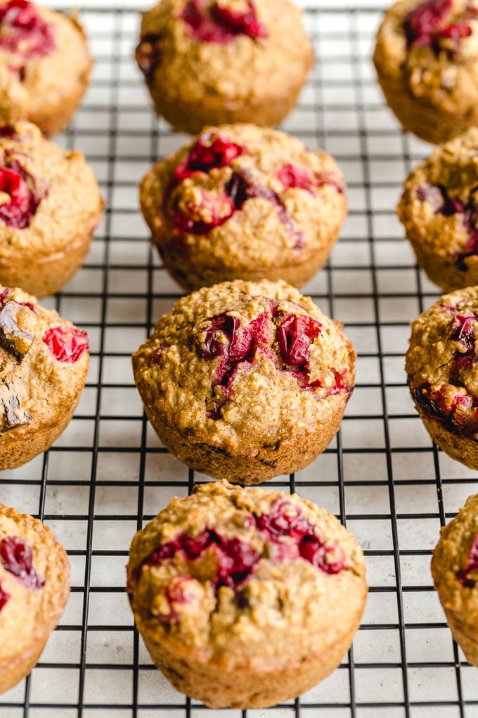 Cranberry muffins cooling on a wire rack.
