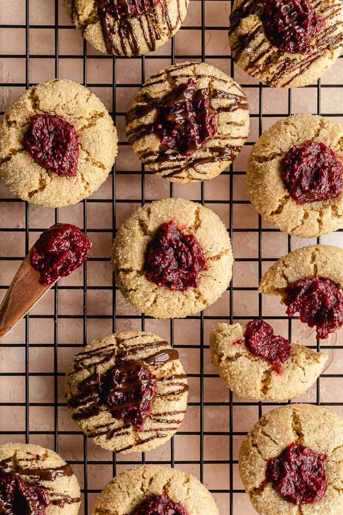 Overhead view of cranberry orange thumbprint cookies on a wire rack.