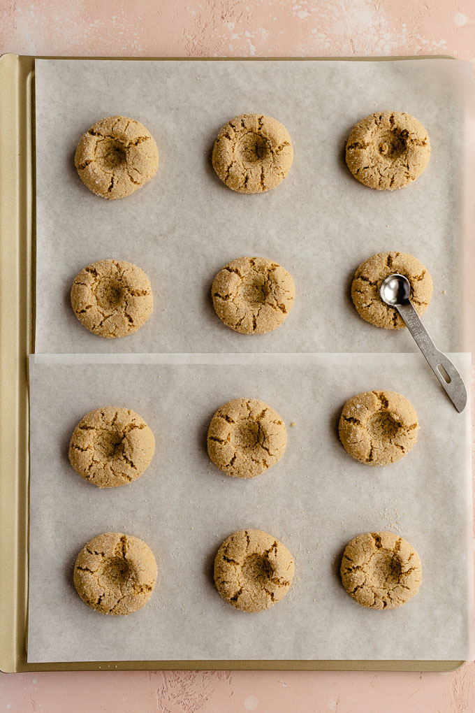 Baked thumbprint cookies on a baking sheet without filling.