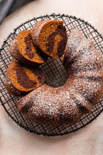 Overhead pumpkin bundt cake with some cut into slices.