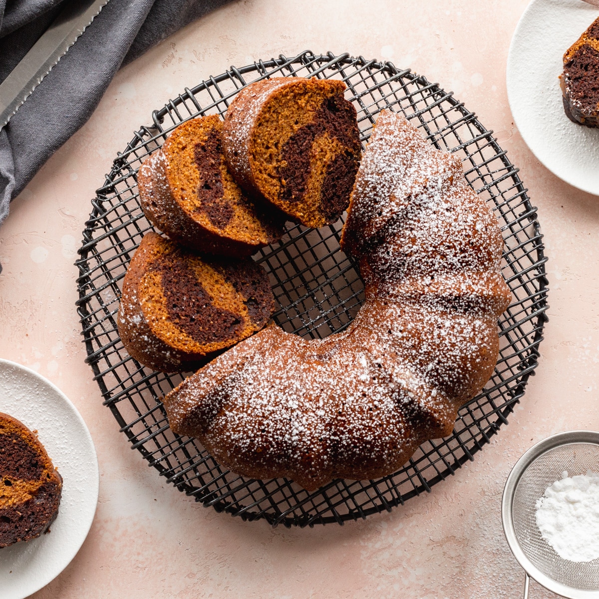 Overhead pumpkin bundt cake with some cut into slices.