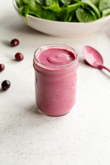 Cranberry salad dressing in a glass mason jar.