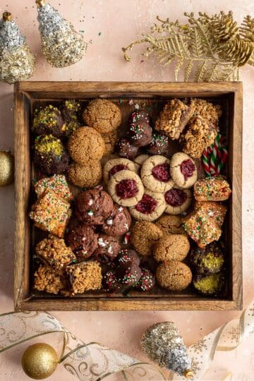 Assorted dairy-free cookies arranged in a holiday cookie box.