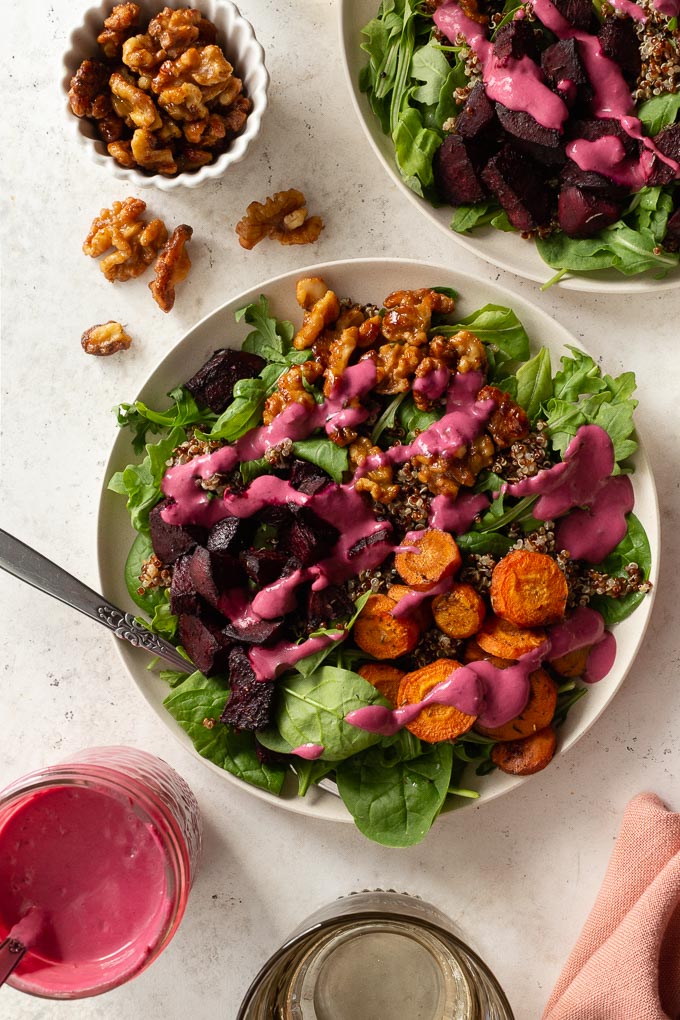 Up-close overhead view of roasted beet salad topped with cranberry salad dressing.