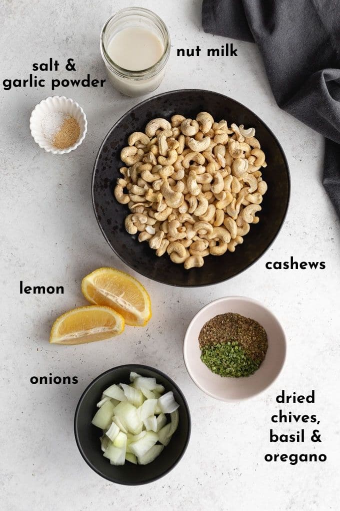 Ingredients to make herbed cashew spread arranged individually and labelled.