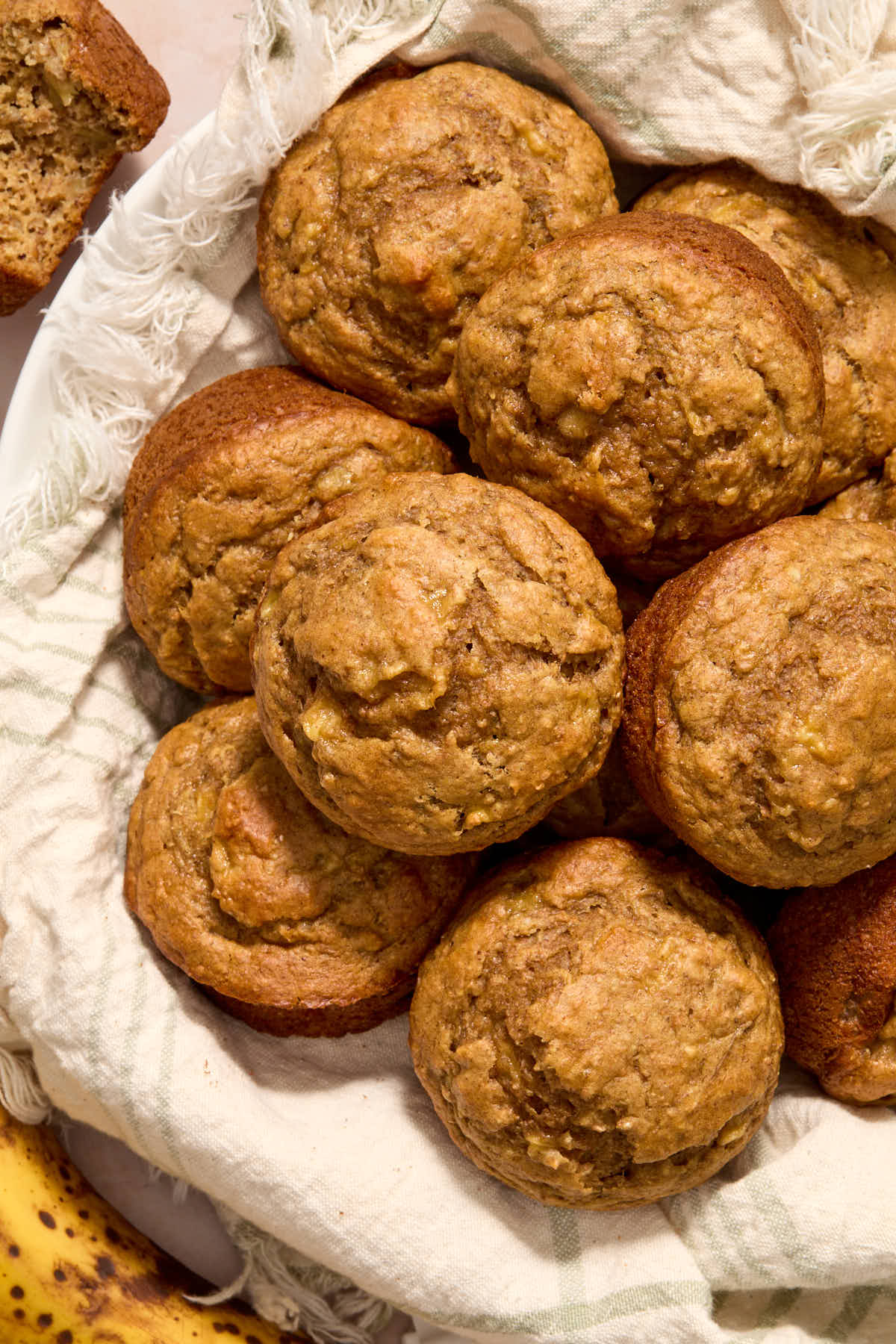Overhead of muffins in a napkin lined basket.
