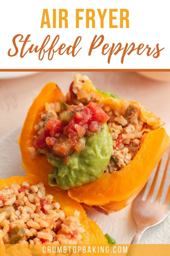 Pinterest image of an air fryer stuffed pepper cut in half on a white plate.