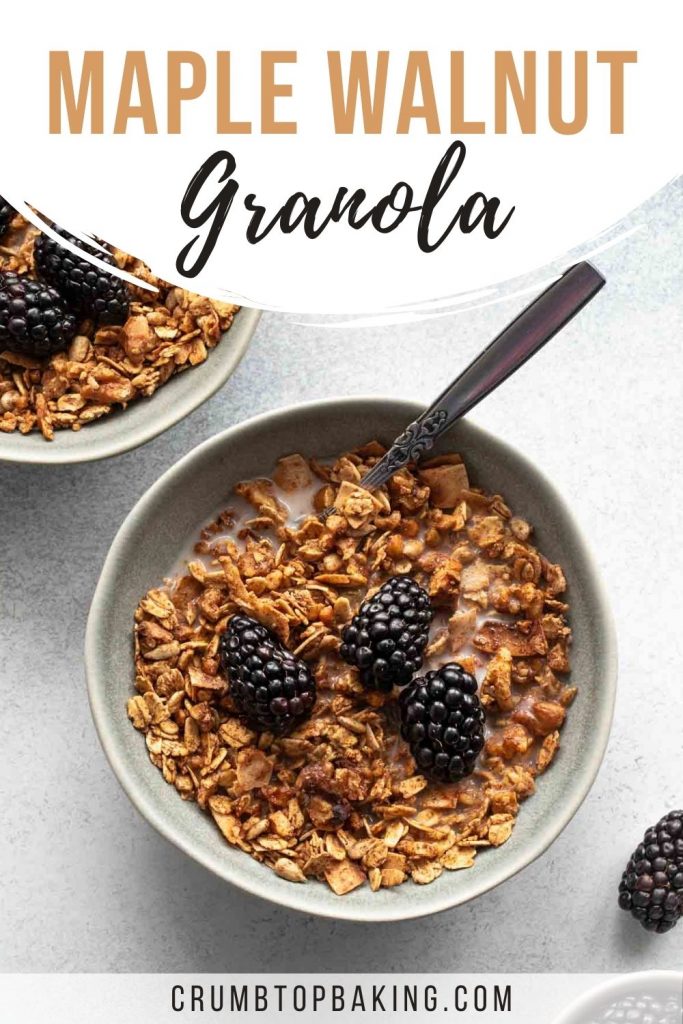 Pinterest image of maple granola in a grey bowl and topped with blackberries.