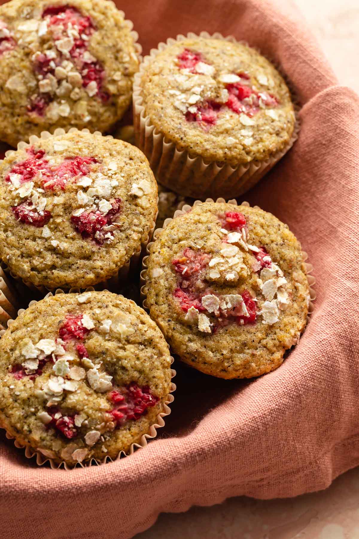 Up close view of raspberry buckwheat muffins in a basket.
