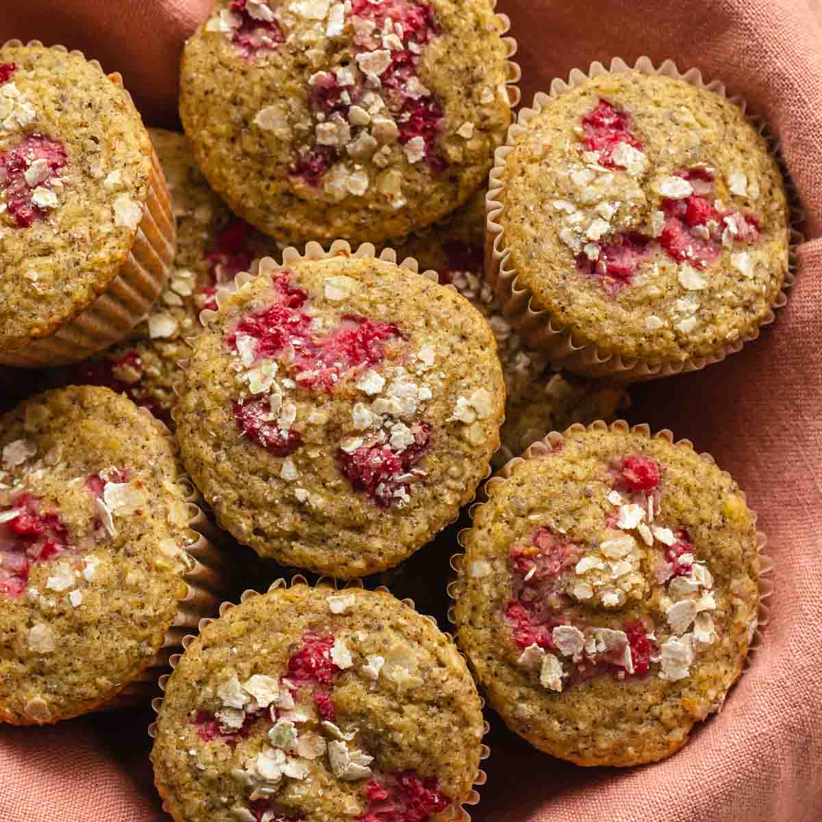 Overhead of lemon raspberry muffins in a basket.