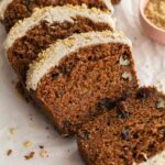 Close up of slices of carrot cake bread with cashew frosting.
