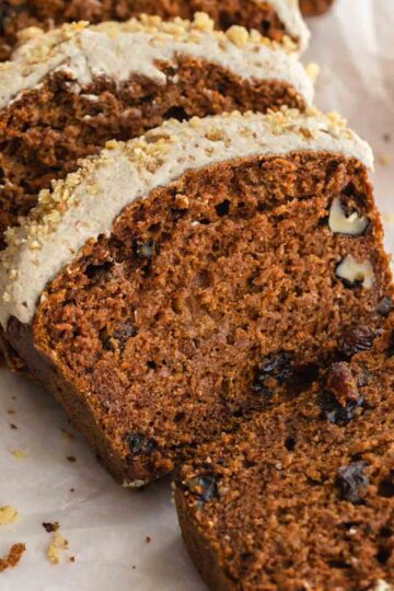 Close up of slices of carrot cake bread with cashew frosting.