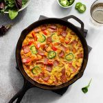 Sweet Potato Frittata with turkey bacon in a cast iron skillet.